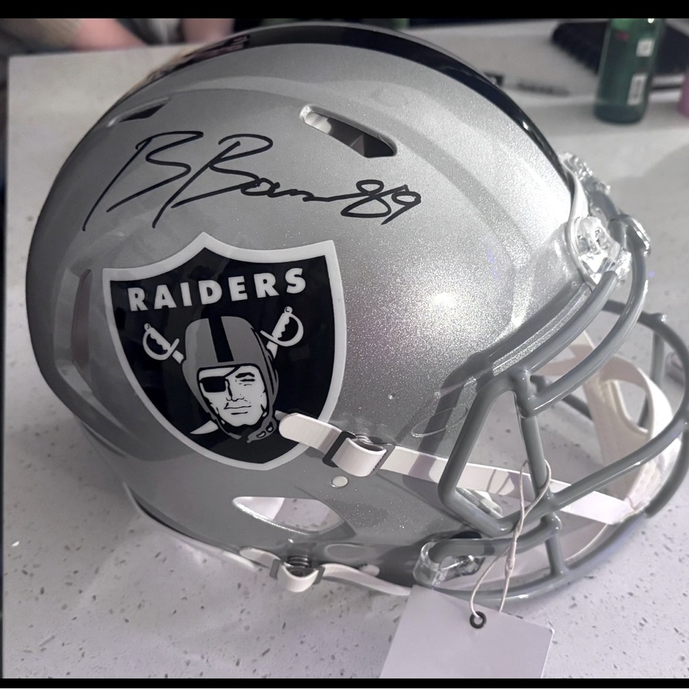 Raiders full speed helmet signed by Brock Bowers. Gold bag